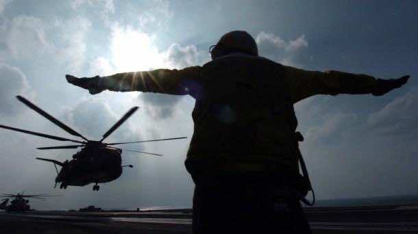 US serviceman signals helicopter at the Gulf south of Iraq