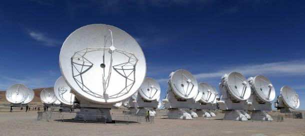 Parabolic antennas of the ALMA project are seen at the El Llano de Chajnantor in the Atacama desert