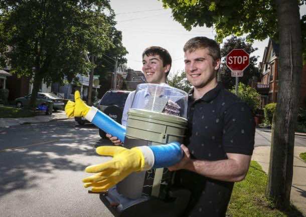 Colin Gagich and Dominik Kaukinen (R), McMaster University mechatronics students, are the makers of the physical HitchBOT. They take they the partially completed robot out for a road test (and a picture). It doesn't talk yet.