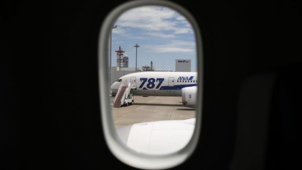 An ANA's Boeing 787-8 Dreamliner airplane is seen through a window of a Boeing 787-9 Dreamliner during a media preview at Haneda airport in Tokyo