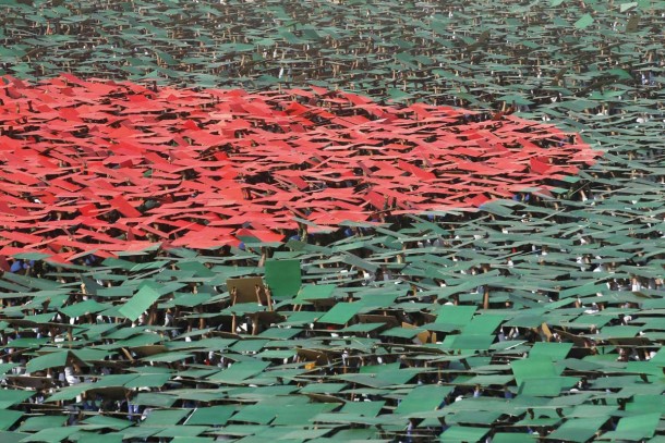 Volunteers prepare to form a large flag of Bangladesh as the nation celebrates National Victory Day at the National Parade ground in Dhaka December 16, 2013. According to the organizers, 27,117 volunteers formed a large human national flag for six minutes and sixteen seconds as they attempted to set a new Guinness world record. Bangladesh won independence from Pakistan on December 16, 1971, following a nine-month guerrilla war which cost millions of lives. REUTERS/Andrew Biraj (BANGLADESH - Tags: POLITICS ANNIVERSARY SOCIETY TPX IMAGES OF THE DAY) ORG XMIT: DHA006