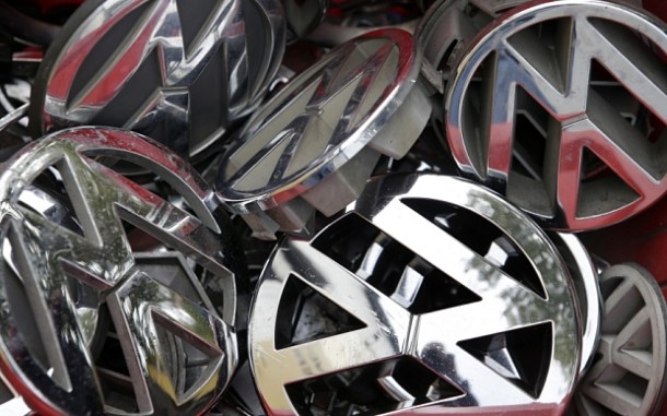FILE - In this Sept. 23, 2015 file photo, company logos of the German car manufacturer Volkswagen sit in a box at a scrap yard in Berlin, Germany. Who knew about the deception, when did they know it and who directed it? Those are among questions that state and federal investigators want answered as they plunge into the emissions scandal at Volkswagen that has cost the chief executive his job, caused stock prices to plummet and could result in billions of dollars in fines. Legal experts say the German automaker is likely to face significant legal problems, including potential criminal charges.  (AP Photo/Michael Sohn, File)