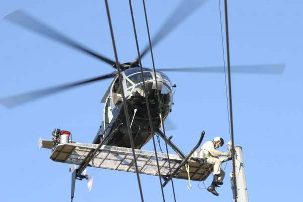 Inspecting Power Lines perched on the outside of a Flying Helicopter Might Be the Most Hazardous Job_Image 1