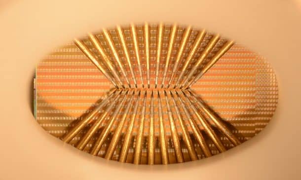 A photo of a wafer full of phase-change devices (the silver squares). The probe needles are required to make the actual thing work: this is a prototype chip. Credits: IBM