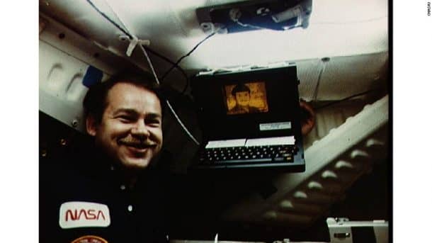 NASA astronaut John Creighton poses with a Grid laptop in a 1985 photo. Credits: NASA