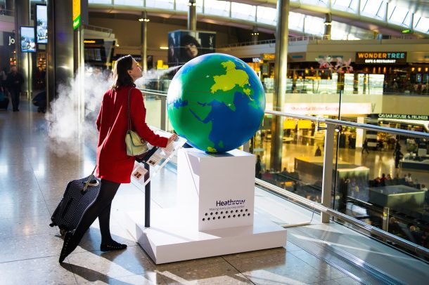 Tuesday 28th October 2014. Heathrow Airport, London: Heathrow brings to life global scents for passengers with a fragrant and interactive installation in Terminal 2 As they enter the departure lounge, travellers are confronted by the giant, one-of-a-kind ‘scent globe’ which will immerse the curious in the aromas of Thailand; South Africa; Japan; China and Brazil. This picture: Passenger Laura Greene from North London tries out the installation For more information, please contact Surname & Surname on +44 (0)207 260 2770 or email heathrowteam@thisissurname.com. PR Handout Copyright: © Mikael Buck / Heathrow +44 (0) 782 820 1042 http://www.mikaelbuck.com