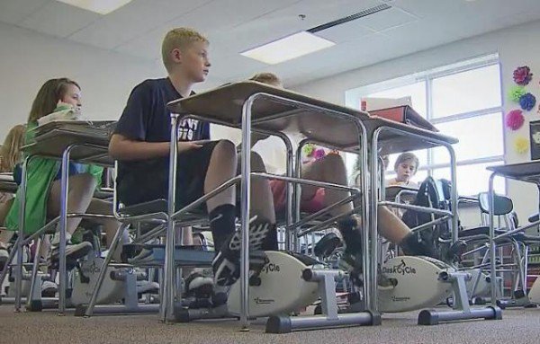 teacher-installs-cycling-machines-under-the-students-desks-to-help-them-concentrate_image-0