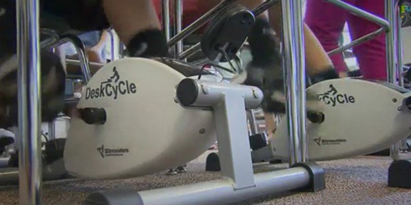teacher-installs-cycling-machines-under-the-students-desks-to-help-them-concentrate_image-1