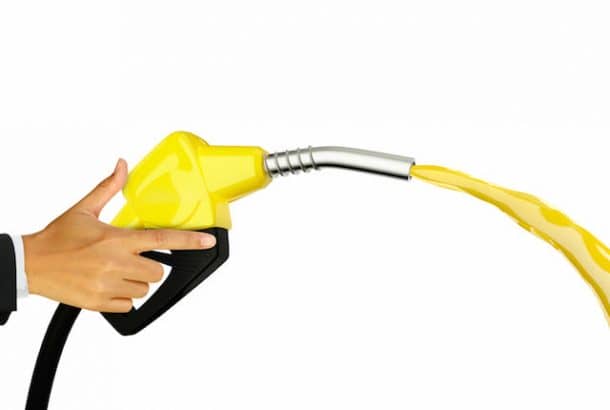 Hand holding Fuel nozzle with hose isolated on white background