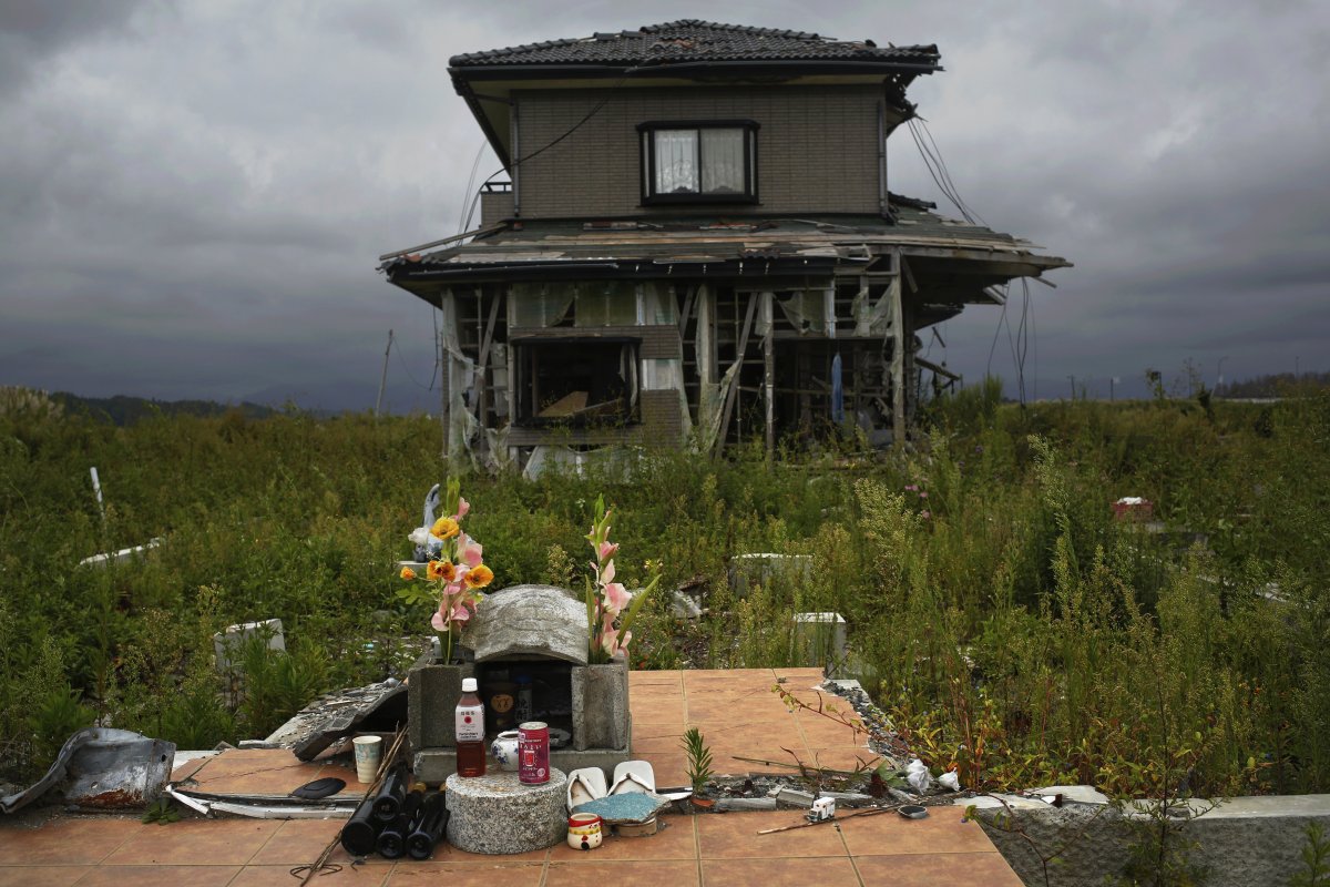 A small monument to victims is seen in front of an abandoned house at the tsunami destroyed coastal area.