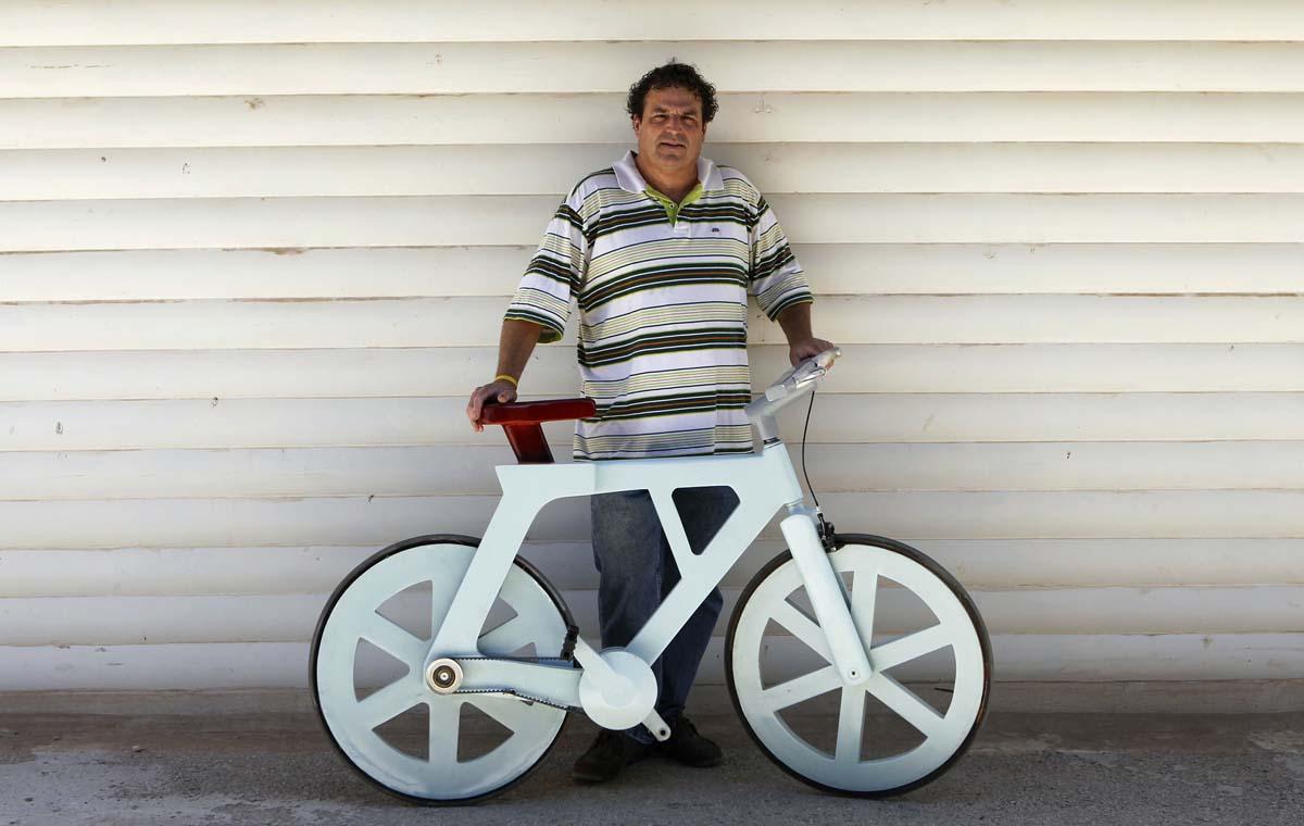 Israeli inventor Izhar Gafni poses for a photo with his cardboard bicycle in Ahituv