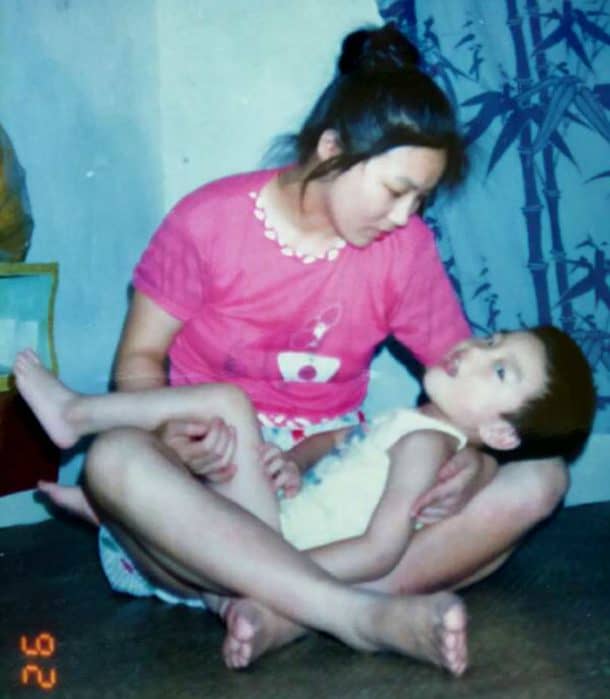 Chinese mother Zuo Hongyan holding her son Ding Ding.